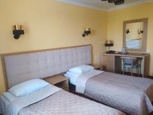 Postel nebo postele na pokoji v ubytování Hotel Ternopil