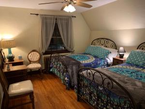 a bedroom with two beds and a ceiling fan at Georgian Garden in Windham