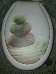 a stack of three rocks in a toilet bowl at Serres citycenter.Free parking place in 100m in Serres