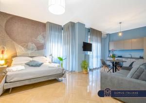 a bedroom with a bed and a living room at City Gate - luxury suites in Bari