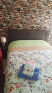 a bed with two pillows on top of it at Serres citycenter.Free parking place in 100m in Serres +14 photos