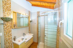 a bathroom with a sink and a shower at Elena's Seaside Apartments & Studios in Agios Gordios