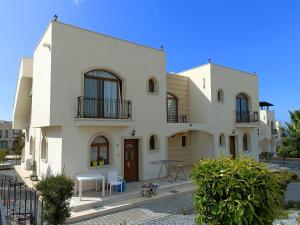 a large white house with a courtyard at Sunny, big pool, garden-roof terrace view Cornervilla on area Kyrenia-Bahceli North-Cyprus in Bahçeli