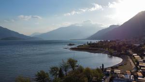 a view of a beach with mountains in the background at Camping Hotel Au Lac De Como in Sorico