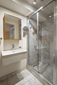 a bathroom with a sink and a glass shower at Charming Bright Modern Design 1bd Home #282 in Istanbul
