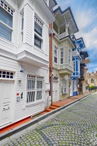 a row of white houses on a cobblestone street at Charming Bright Modern Design 1bd Home #282 in Istanbul