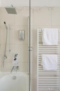 a bathroom with a shower and a tub and a sink at Résidence étoile in Saint-Yrieix-la-Perche