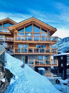 a log house in the mountains with snow at Luxury Chalet Engedi in Saas-Fee