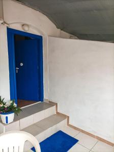 a room with a blue door and a blue rug at Sea View Studio Armenistis Ikarias in Armenistis