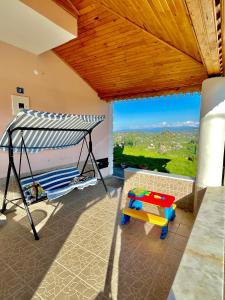 a room with a swing and a balcony with a view at Nature Family House in Arsin