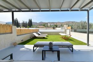 an outdoor patio with a view of a yard at Swan Paradise Residences in Loutra Oraias Elenis