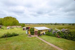 a small house in a field with a yard at Urlaubs-Appartement am Dorfrand in Wieck