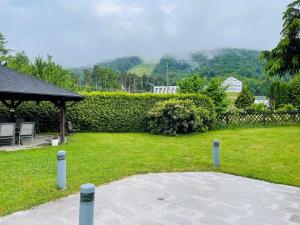 a yard with a gazebo and a grassy yard with at Boutique Hotel Pohorje in Maribor