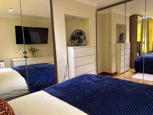 1 Schlafzimmer mit 2 Betten und einem großen Spiegel in der Unterkunft Shared house on Southmead in Bristol