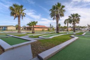 a park with palm trees and a golf course at Wollongong Surf Leisure Resort in Wollongong