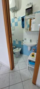 a bathroom with a toilet and a sink at Noto Sole di Sicilia in Noto Marina +89 photos