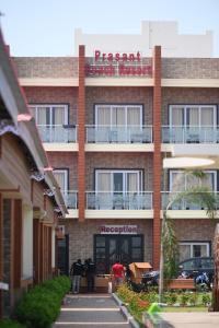 a building with people standing outside of it at Prasant Beach Resort in Mandarmoni