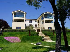 a large white building with two windows at Magnificat Hotel&Resort in Canosa Sannita