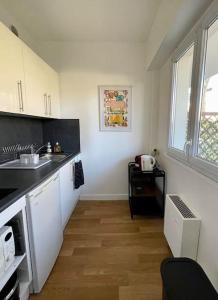 a kitchen with a sink and a counter at Studio Le Pied à Mer in Houlgate