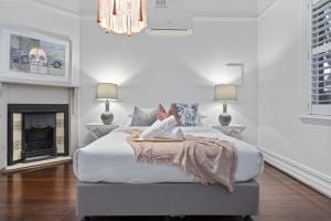 a woman laying on a bed in a bedroom at Picture Perfect Create timeless treasures in Perth