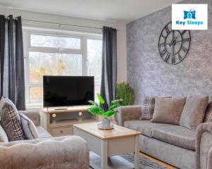 a living room with two couches and a television at Four Bedroom By Keysleeps Short Lets Peterborough With Free Parking Spacious Central Contractor in Peterborough