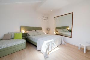 a bedroom with two beds and a large mirror at La casa di Gabri Trieste centro in Trieste