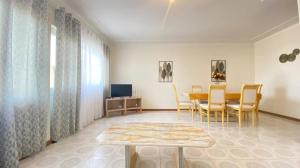 a living room with a dining room table and chairs at Perfect Place in Tarrafal