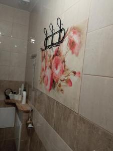 a painting of flowers on the wall of a bathroom at Ozierański Eden "Pod rzeźbami" 