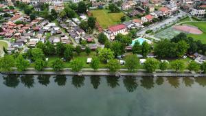 an aerial view of a village next to a river at Camping Hotel Au Lac De Como in Sorico