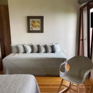 a bedroom with a bed and a chair in it at Kalderimi Country House in Mouresi