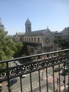 a large building with a clock tower in a city at Bel appartement Montparnasse 70m2 in Paris