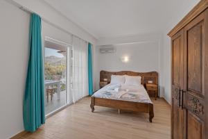 a bedroom with a bed and a sliding glass door at Blue Time Boutique Hotel in Marmaris
