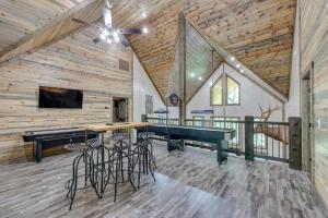 a room with a ping pong table and a ceiling fan at Gorgeous Broken Bow Family Home with Private Hot Tub in Broken Bow