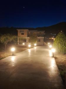 a driveway lit up with lights at night at Central House 2 in Ancient Epidauros