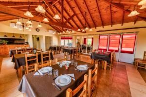 a dining room with tables and chairs in a restaurant at Los Llantenes in San Andres de las Sierras