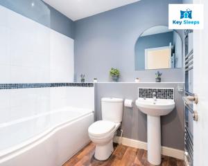 a bathroom with a white toilet and a sink at Spacious Contractor House Leisure By Keysleeps Short Lets Derby With Free Parking in Derby