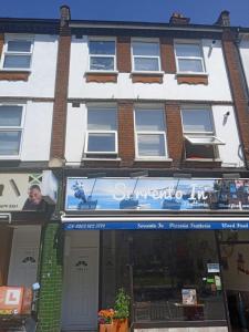 a building with a sign on the front of it at LondonRooms in London