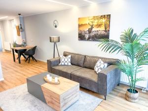 a living room with a couch and a table at Appartement am Mythenweg in Thale +6 photos