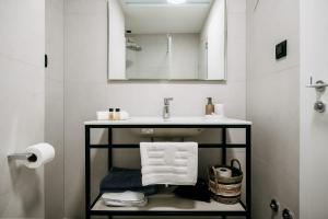 a bathroom with a sink and a mirror at KALA LUXURY ROOMS by DuHomes in Dubrovnik