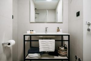 a bathroom with a sink and a mirror at KALA LUXURY ROOMS by DuHomes in Dubrovnik