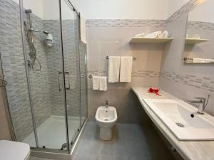 a bathroom with a shower and a toilet and a sink at B&B Le Onde Del Mare in San Vito lo Capo +22 photos