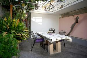 a table and chairs in a room with plants at Central Eden - ZF Hvar in Hvar