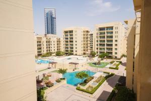 a view of a pool in a city with buildings at Luton Vacation Homes - Cozy1BR , Al Dhafra Tower 1 - Dubai Greens - 40AB1 in Dubai