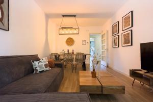 a living room with a couch and a table at The Lonely Chimney Apartments in Barcelona