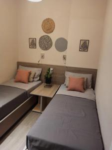 a room with two beds and a table at Achlia Beach Apartments 2 in Achlia