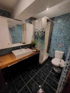 a bathroom with a tub and a toilet and a sink at Achlia Beach Apartments 2 in Achlia