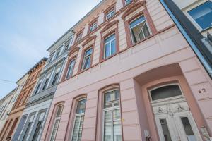 a pink building with a lot of windows at Dream for 4 - Smart TV in Krefeld