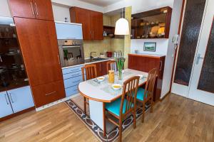 a kitchen with a table and chairs in a room at Sea & Me, pleasant seaside home in Portorož