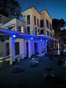 a white house with blue lights on it at night at Pinar Suites Loft in Torremolinos