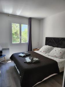 una camera da letto con un grande letto con due asciugamani di T3 avec magnifique vue montagne, 3 étoiles, piscine et parking, clim a Mougins